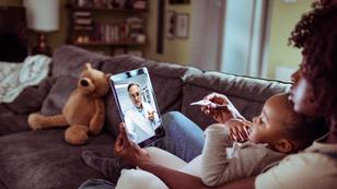 Close up of a mother and daughter consulting with their doctor over a video call on their digital tablet, photo by Geber86/Getty Images
