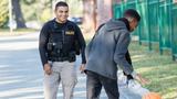 Young Hispanic police officer and an African-American teenage boy, photo by kali9/Getty Images