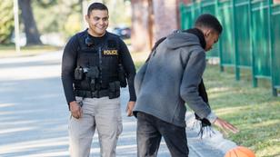Young Hispanic police officer and an African-American teenage boy, photo by kali9/Getty Images
