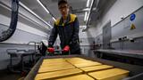 An employee transports ingots of gold during production at Krastsvetmet precious metals plant in Krasnoyarsk, Russia, May 23, 2024, photo by Alexander Manzyuk/Reuters