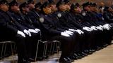 Police officers take part in a NYPD Promotion Ceremony at Police Headquarters in Manhattan, New York, December 19, 2014, photo by Carlo Allegri/Reuters 
