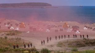 Soldiers in red hats acting as invaders run inland from Bali beach as part of an annual defense exercise in New Taipei City, Taiwan, July 27, 2022, photo by Ann Wang/Reuters
