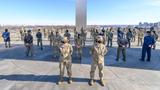 Lt. Gen. Mary F. O’Brien and Chief Master Sgt. of the Air Force JoAnne S. Bass stand in front of a group of female Airmen demonstrating the Air Force’s hair policy for women in front of the Air Force Memorial in Arlington, VA, January 21, 2021, photo by Master Sgt. Grant Langford/U.S. Air Force
