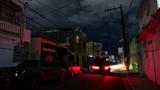 A car drives through a dark street after a grid failure left nearly all of the island without power, in San Juan, Puerto Rico, December 31, 2024, photo by Ricardo Arduengo/Reuters