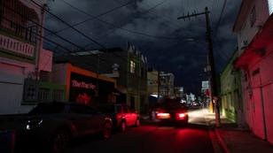 A car drives through a dark street after a grid failure left nearly all of the island without power, in San Juan, Puerto Rico, December 31, 2024, photo by Ricardo Arduengo/Reuters