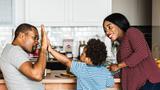 Black father, mother, and child in the kitchen together, photo by Rawpixel.com/Adobe Stock