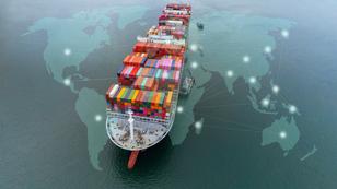 Aerial view of a cargo ship over a world map, image by APchanel/Adobe Stock