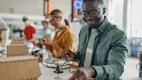 Black man working in a tech lab, photo by supersizer/Getty Images