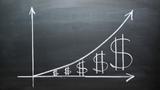 Growth chart with dollar signs on a chalk board, photo by Yestock/Getty Images