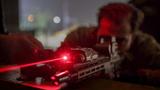 An Army Green Beret adjusts a laser sight to engage targets in low light conditions during Trojan Footprint 2024 near Sofia, Bulgaria, March 1, 2024. U.S. Army photo by Sgt. Alejandro Lucero.