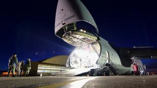 A C-5M Super Galaxy opens its front-facing cargo hold at night