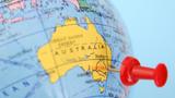 Closeup of a globe focused on Australia, with a pushpin in Canberra, photo by FotografiaBasica/Getty Images