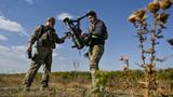 Ukrainian service members prepare to test an FPV drone with an attached portable grenade launcher in the Zaporizhzhia region, Ukraine, October 11, 2024, photo by Stringer/Reuters