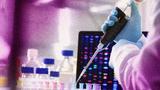 Scientist in a a lab, photo by Andrew Brookes/Getty Images