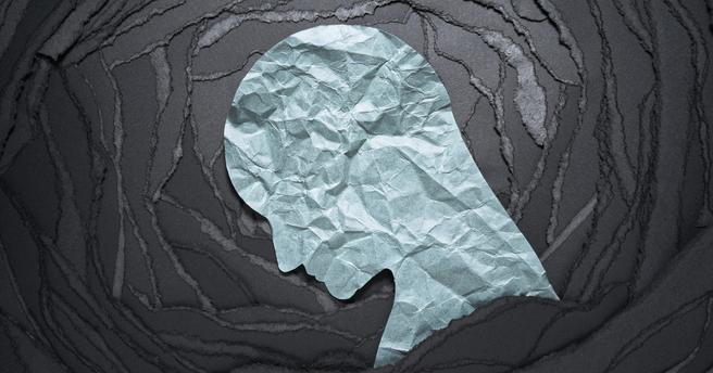 Paper collage of a light blue head looking downward, on top of concentric black frames, photo by tadamichi/Getty Images
