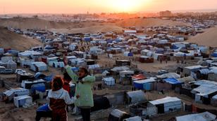 Displaced Palestinian children talk to each other as they shelter in a tent camp in Khan Younis, southern Gaza Strip, December 29, 2024, photo by Mohammed Salem/Reuters