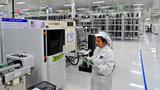 A worker at a factory that makes electronic products for new-energy vehicles, in a high-tech industrial park in Fengcheng, China, February 6, 2025, photo by Zhu Haipeng/VCG via Reuters
