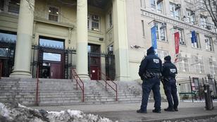 Two NYPD officers outside Theodore Roosevelt High School in the Fordham section of Bronx, New York, after a report of a teenage boy being slashed across the face, February 13, 2025, photo by Kyle Mazza/NurPhoto via Reuters