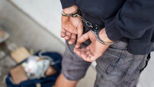 Close up of a man handcuffed with illegal drugs on the ground next to him, photo by Impact Photography/Adobe Stock 