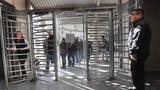 Individuals pass through metal gates, photo by John Moore/Getty Images