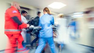 Paramedics and a nurse pushing a gurney in a hospital, photo by vm/Getty Images