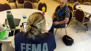 A FEMA worker talks to a local resident affected by floods following Hurricane Helene in Marion, North Carolina, October 5, 2024, photo by Eduardo Munoz/Reuters