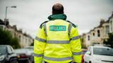 Back of male paramedic on neighborhood street, photo by Rawpixel/Getty Images