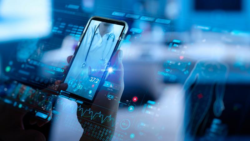 Close up of a hand holding a smartphone displaying a call with a doctor, photo by greenbutterfly/Adobe Stock