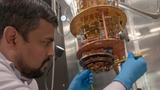 A scientist from the Laboratory for Physical Sciences loading a high quality factor superconductor resonator on the measurement state of an adiabatic demagnetization refrigerator that can reach temperatures as low as 50 mK, photo by Laboratory for Physical Sciences/Quantum Image Gallery.
