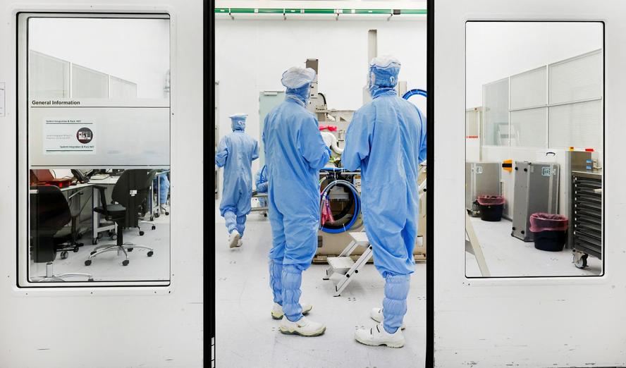 Assembly engineers work on a TWINSCAN DUV lithography system at ASML in Veldhoven, Netherlands, June 16, 2023, photo by Piroschka van de Wouw/Reuters