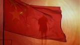 China flag over a figure of a man and a skyline, photo by TheaDesign/Getty Images