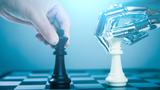 Closeup of a human hand and a robot hand playing chess, photo by xijian/Getty Images