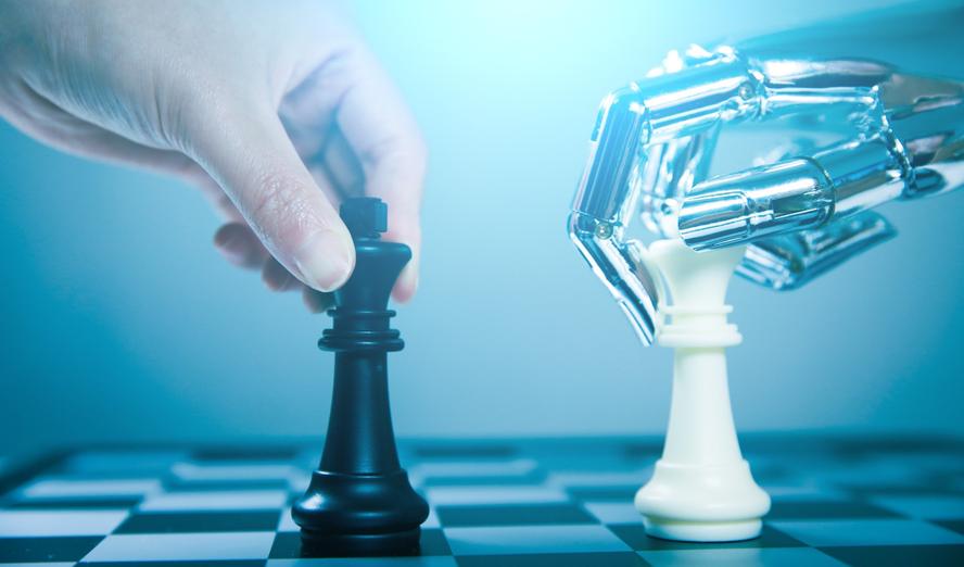 Closeup of a human hand and a robot hand playing chess, photo by xijian/Getty Images