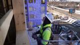 Carpenter Paul Olson, a new apprentice in construction, works to install exterior sheet rock on an apartment complex in Minneapolis, Minnesota, March 14, 2023, photo by Anthony Souffle/TNS/ABACA via Reuters