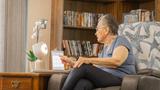 An elderly women tests a robot companion in New York, June 7, 2022, photo by ElliQ/Cover Images via Reuters Connect