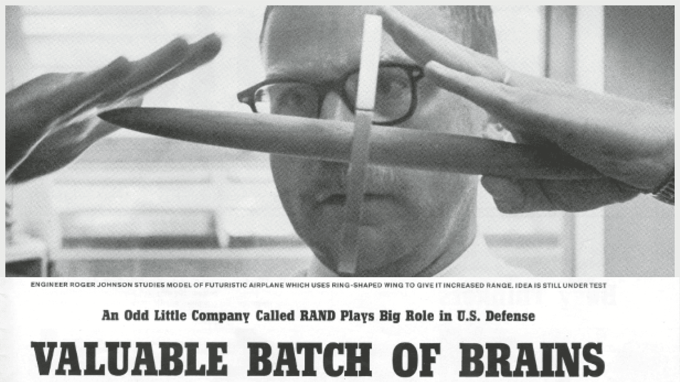 RAND researcher Roger Johnson studies model of futuristic airplane. LIFE Magazine article, 1959